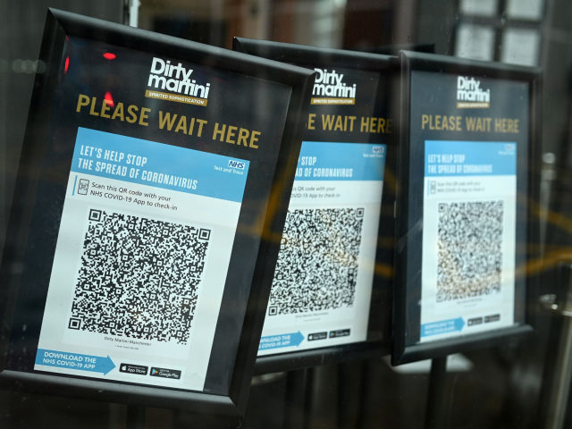 Track and trace QR codes are displayed outside a pub, in Manchester, north west England on October 13, 2020, as the number of cases of the novel coronavirus COVID-19 continue to rise. - The British government faced renewed pressure on October 13, after indications it had ignored scientific advice three …