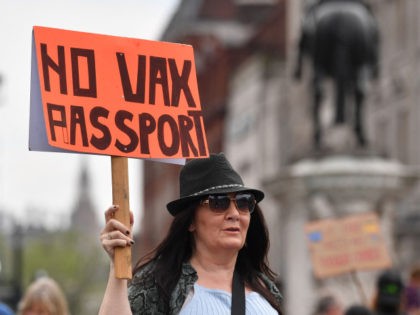 A protestor displays an anti-vax placard during a 'Unite For Freedom' march against Covid-