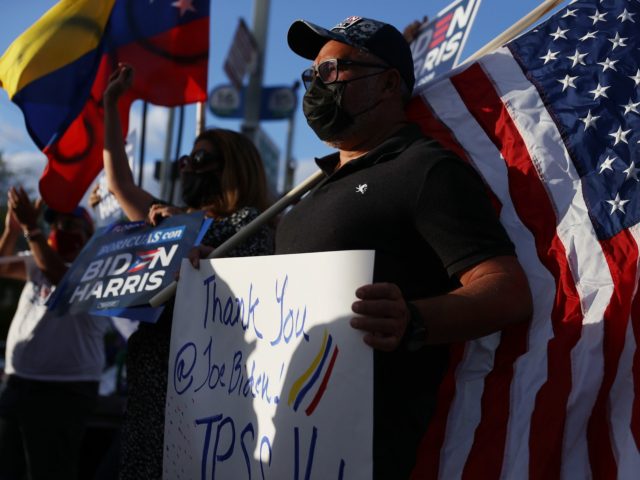 DORAL, FLORIDA - MARCH 09: Jesus Aranguren, originally from Venezuela, and others gather in front of the El Arepazo restaurant to show their support for an order signed by U.S. President Joe Biden that grants temporary protective status for thousands of Venezuelans on March 09, 2021 in Doral, Florida. The …