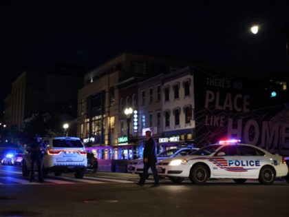 WASHINGTON, DC - JULY 22: Police investigate a shooting on July 22, 2021 in Washington, DC. Gunfire erupted on a busy street, injuring two and sending others fleeing for safety. A dark sedan was being sought in connection with the shooting and the two injured were expected to survive, according …