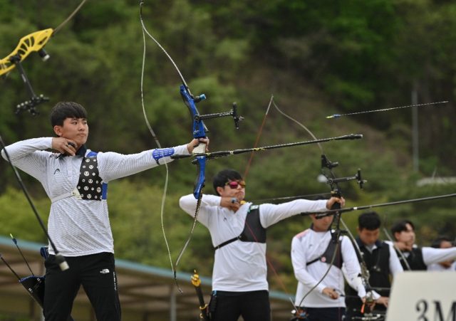 Arrows away: South Korean archer Kim Je-deok (left) competes during the final round of the