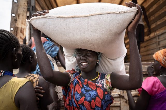 South Sudan is the world's youngest country but also one of the poorest. A woman carries a