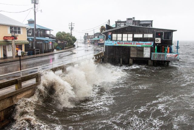 Waves batter a pier as Tropical Storm Elsa makes landfall in Cedar Key, Florida