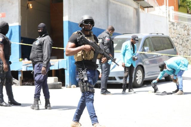 Haitian police and forensics teams look for evidence outside the presidential residence fo