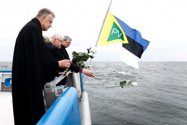 Bishops throw white rose into the sea at the start of a new inquiry into the 1994 sinking