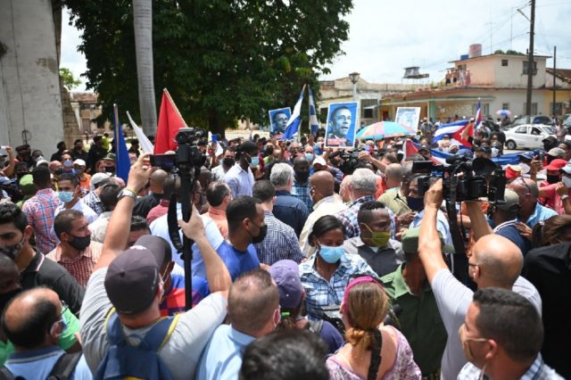 Cuban President Miguel Diaz-Canel (C) is seen during a demonstration held by citizens to demand improvements in the country, in San Antonio de los Banos, Cuba, on July 11, 2021