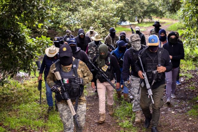 Members of the Mexican self-defense group Pueblos Unidos guard avocado plantations in the