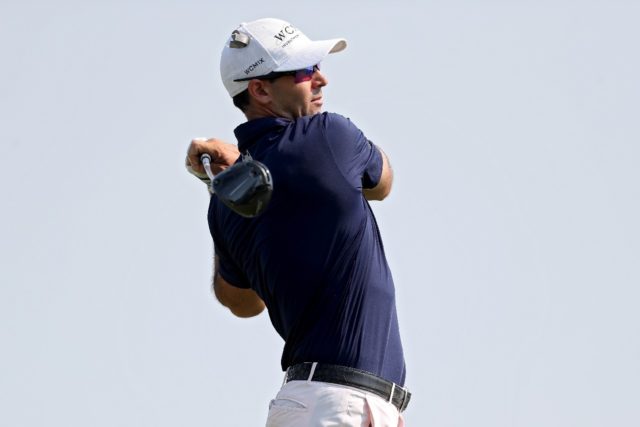 American Cameron Tringale plays his shot from the 18th tee during the third round of the 3