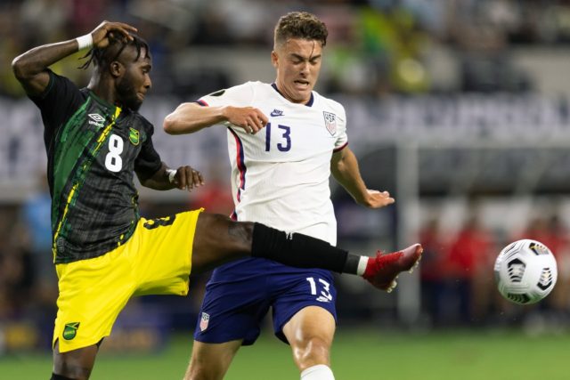 Jamaica's defender Oniel Fisher (left) vies for the ball with American forward Matthew Hoppe during the Concacaf Gold Cup quarter-final in Texas