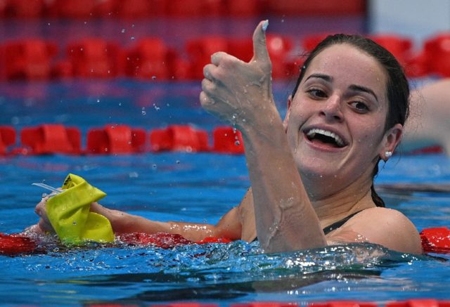 Australia's Kaylee McKeown celebrates after winning the women's 100m backstroke final at t