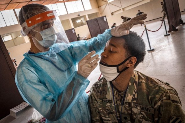 A US army soldier is tested for Covid-19 upon arrival at Morocco's Agadir military airport
