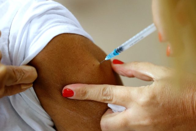 A patient receives a third dose of the Pfizer-BioNTech coronavirus vaccine at Sheba Medica
