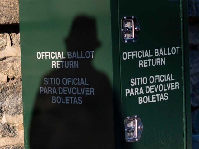 PHILADELPHIA, PA - OCTOBER 17: A pedestrian casts a shadow on an early voting ballot at dr