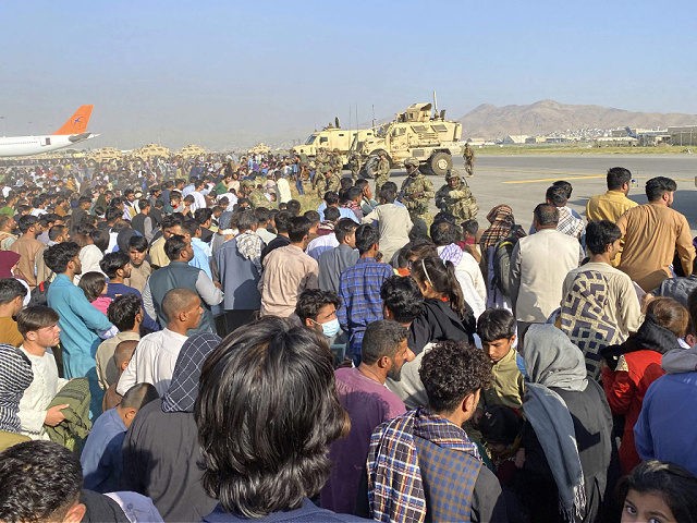 U.S soldiers stand guard along a perimeter at the international airport in Kabul, Afghanistan, Monday, Aug. 16, 2021. On Monday, the U.S. military and officials focus was on Kabulâ€™s airport, where thousands of Afghans trapped by the sudden Taliban takeover rushed the tarmac and clung to U.S. military planes deployed …