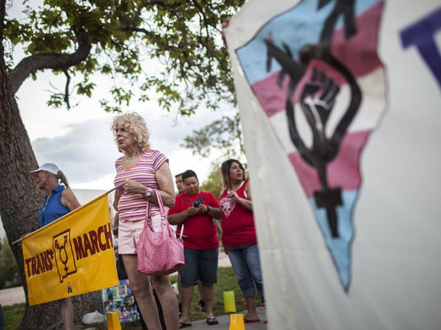 In this May 29, 2014 photo, Denee Mallon, second from left, takes part in the Trans March to Morningside Park in Albuquerque, N.M. A U.S. Department of Health and Services review board ruled Friday, May 30, in favor of Mallon, a 74-year-old Army veteran, whose request to have Medicare pay for her genital reconstruction was denied two years ago. The decision recognizes sex reassignment surgeries as a medically necessary and effective treatment for individuals who do not identify with their biological sex. (AP Photo/Craig Fritz)