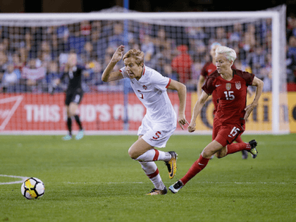 Canada defender Rebecca Quinn (5) and United States forward Megan Rapinoe (15) chase after