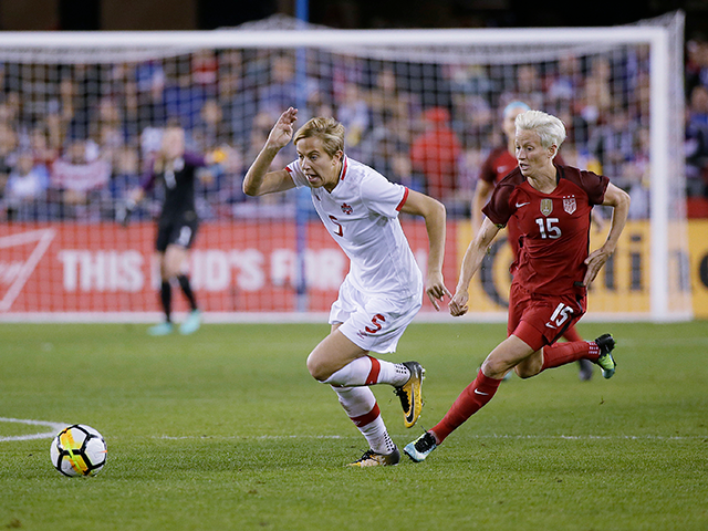 Canada defender Rebecca Quinn (5) and United States forward Megan Rapinoe (15) chase after the ball during the first half of an international friendly women's soccer match, Sunday, Nov. 12, 2017, in San Jose, Calif. (AP Photo/Eric Risberg)