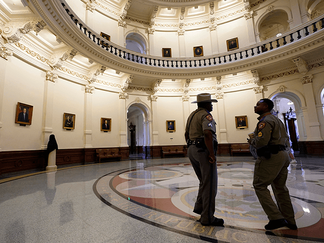 Texas Department of Safety officers stand watch over the Texas Capitol, Wednesday, Aug. 11