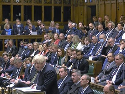 Britain's Prime Minister Boris Johnson speaks during the debate on the situation in Afghanistan inside parliament in London, as lawmakers attend an emergency sitting three days after the Afghanistan capital Kabul fell to the Taliban. Nearly all ruling Conservative Party lawmakers were not wearing face masks during the debate Wednesday, …