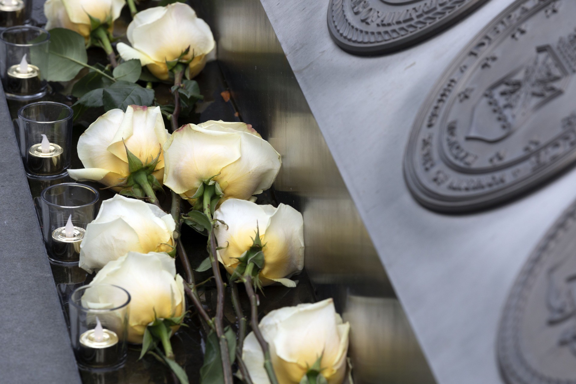 Roses and candles lie at the Massachusetts Fallen Heroes Memorial, Saturday after being placed during a ceremony, Aug. 28, 2021, in Boston. The ceremony was held to honor the U.S. service members killed in a suicide bombing at the airport in Kabul, Afghanistan, including Marine Sgt. Johanny Rosario Pichardo of Lawrence, Mass. (AP Photo/Michael Dwyer)