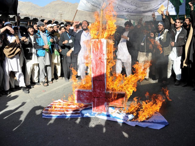 Afghan university students torch an upside-down cross, along with U.S. and Israeli flags during a demonstration against Israel and the U.S. in Nangarhar province at Jalalabad, Afghanistan, on November 26, 2012. (Noorullah Shirzada/AFP via Getty Images)