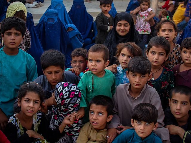 Children from the Internally displaced Afghan families arriving from districts of Khan Abad, Ali Abad and Imam Sahib who fled due to the ongoing battles between Taliban and Afghan security forces, look on inside the premises of a school in Kunduz city on June 26, 2021. (Photo by STR / …