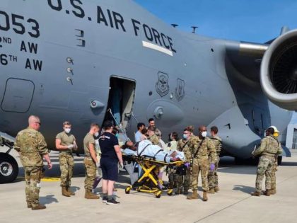 Medical support personnel from the 86th Medical Group help an Afghan mother and family off a U.S. Air Force C-17, call sign Reach 828, moments after she delivered a child aboard the aircraft upon landing at Ramstein Air Base, Germany, Aug. 21. (cont..)