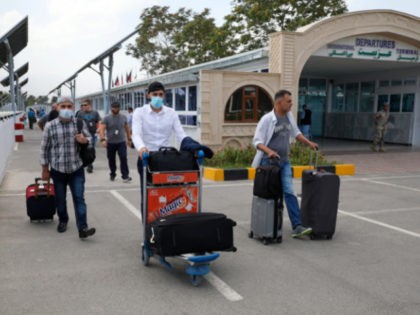 Passengers walk from the domestic terminal at Hamid Karzai International Airport in Kabul,
