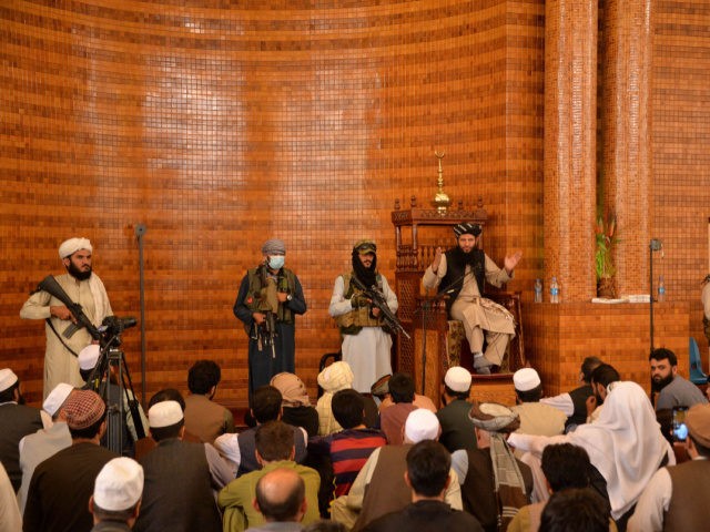 Armed Taliban fighters stand next an Imam during Friday prayers at the Abdul Rahman Mosque in Kabul on August 20, 2021, following the Taliban's stunning takeover of Afghanistan. (Photo by Hoshang Hashimi / AFP) (Photo by HOSHANG HASHIMI/AFP via Getty Images)
