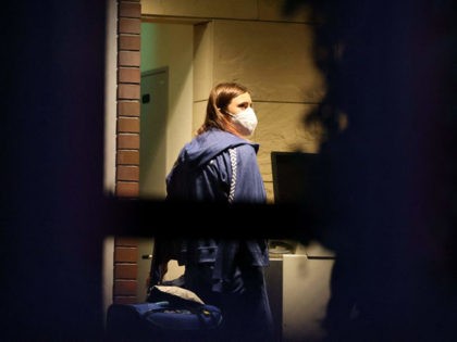TOPSHOT - Belarus athlete Krystsina Tsimanouskaya, who claimed her team tried to force her to leave Japan following a row during the Tokyo 2020 Olympic Games, walks with her luggage inside the Polish embassy in Tokyo on August 2, 2021. (Photo by Yuki IWAMURA / AFP) (Photo by YUKI IWAMURA/AFP …