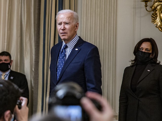 WASHINGTON, DC - MARCH 06: President Joe Biden stops to answer questions from reporters after speaking in the State Dining Room with Vice President Kamala Harris behind him following the passage of the American Rescue Plan in the U.S. Senate at the White House on March 6, 2021 in Washington, …