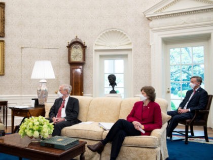 Senator Angus S. King Jr. (I-ME), Senator Jeanne Shaheen (D-NH), and Senator John Hickenlooper (D-CO) listens while US President Joe Biden(L) speaks before a meeting about the American Jobs Plan in the Oval Office of the White House April 19, 2021, in Washington, DC. (Photo by Brendan Smialowski / AFP) …