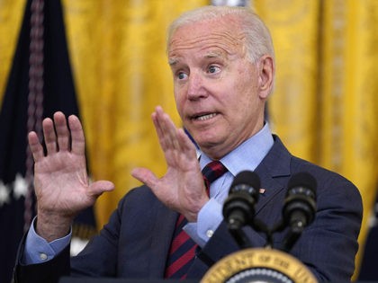 President Joe Biden answers a question from a reporter as he speaks about the coronavirus