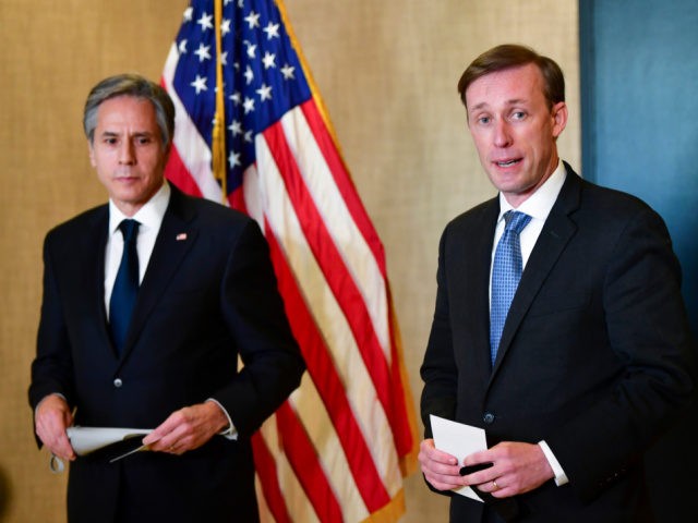 Secretary of State Antony Blinken, left, listens as National Security Adviser Jake Sullivan, right, talks to the media after a closed-door morning session of US-China talks in Anchorage, Alaska on Friday, March 19, 2021. (Frederic J. Brown/Pool via AP)