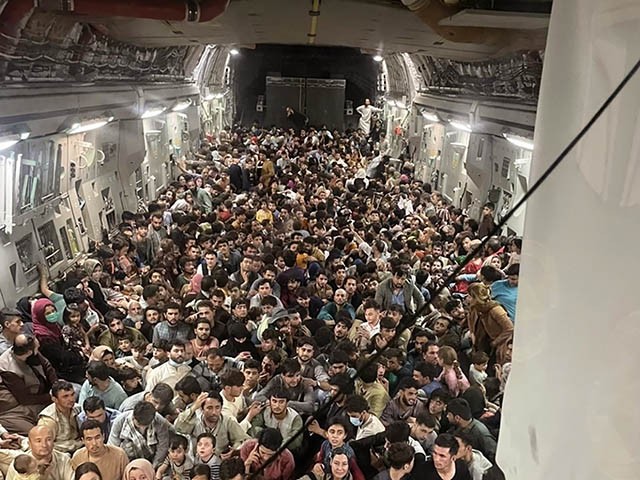 Afghan citizens pack inside a U.S. Air Force C-17 Globemaster III, as they are transported from Hamid Karzai International Airport in Afghanistan, Sunday, Aug. 15, 2021. The Taliban on Sunday swept into Kabul, the Afghan capital, after capturing most of Afghanistan. (Capt. Chris Herbert/U.S. Air Force via AP)