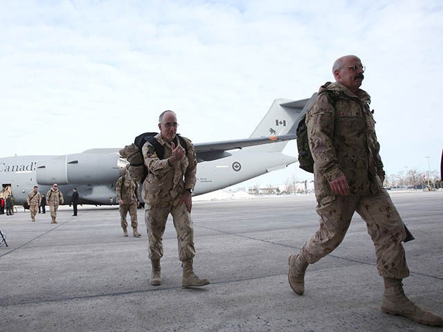 The last Canadian troops to leave Afghanistan, deplane as they return to Canadian soil, in Ottawa, Ontario on March 18, 2014. The last Canadian troops deployed to Afghanistan returned home on Tuesday, bringing an end to Canada's longest ever military engagement. AFP PHOTO/ Cole Burston (Photo credit should read Cole …