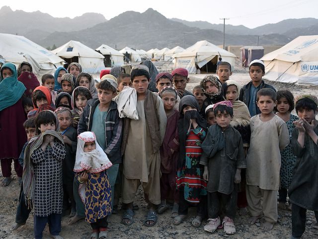 Children pose for photographs in front of their tents at a camp for internally displaced families in Panjwai district of Kandahar province on March 31, 2021. (Photo by JAVED TANVEER / AFP) (Photo by JAVED TANVEER/AFP via Getty Images)
