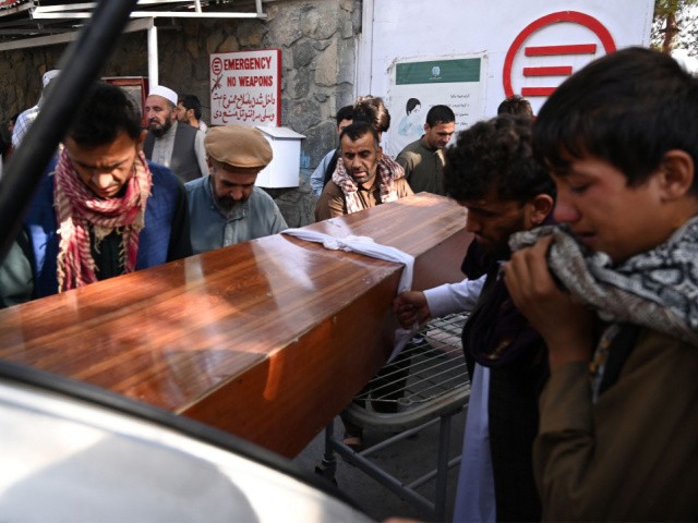 Relatives load in a car the coffin of a victim of the August 26 twin suicide bombs, which killed scores of people including 13 US troops outside Kabul airport, at a hospital run by the Italian NGO Emergency in Kabul on August 27, 2021. (Photo by Aamir QURESHI / AFP) (Photo by AAMIR QURESHI/AFP via Getty Images)