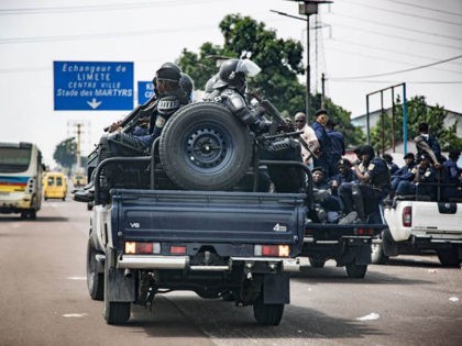 Congolese anti-riot policemen patrol in their vehicles in the streets of the popular N'djili (or Ndjili) district, in Kinshasa, on December 30, 2018 during the Democratic Republic of Congo's general elections. - Voters in the Democratic Republic of Congo went to the polls on December 30, 2018 in elections that …