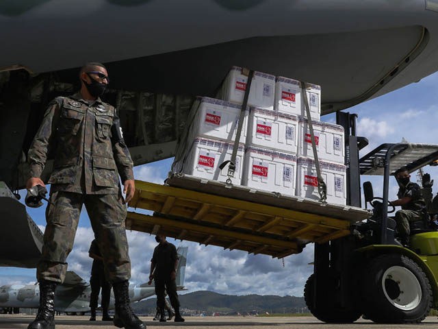 SAO PAULO, BRAZIL - JANUARY 18: Military personnel do the loading of the nearly 6 million doses of the CoronaVac vaccine, developed by the Chinese laboratory Sinovac in partnership with the Butantan Institute, to be distributed to all Brazilian states on January 18, 2021 in Sao Paulo, Brazil. The vaccines …