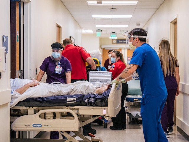 HOUSTON, TEXAS - AUGUST 18: Emergency Room nurses and EMTs tend to patients in hallways at the Houston Methodist The Woodlands Hospital on August 18, 2021 in Houston, Texas. Across Houston, hospitals have been forced to treat hundreds of patients in hallways and corridors as their emergency rooms are being overwhelmed due to the sharp increase in Delta variant cases. Hospitals are straining to keep up with the surge of new coronavirus patients as schools and businesses continue to reopen. Houston has seen an upward increase in Delta infections, and research is showing the Delta variant to be 60% more contagious than its predecessor the Alpha variant, also known as COVID-19. (Photo by Brandon Bell/Getty Images)