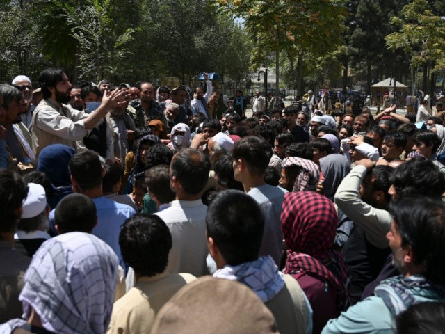 Internally displaced Afghan men, who fled from Kunduz province due to battles between Taliban and Afghan security, gather as they register to recive food at the Shahr-e-Naw Park in Kabul on August 10, 2021. (Photo by WAKIL KOHSAR / AFP) (Photo by WAKIL KOHSAR/AFP via Getty Images)