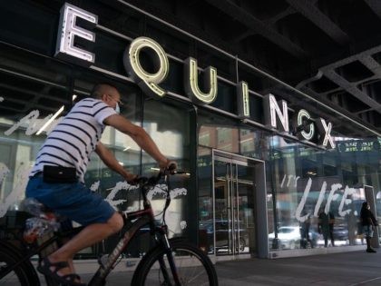 A man rides his bike past the Equinox gym in Chelsea on August 17, 2020 in New York. - NY
