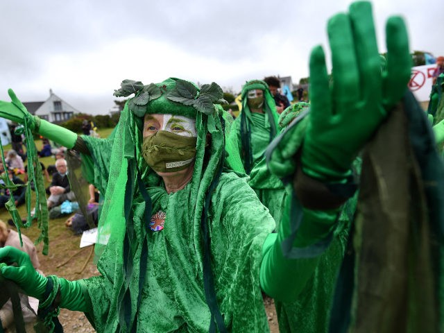TOPSHOT - Activists from the climate change protest group Extinction Rebellion, dressed in