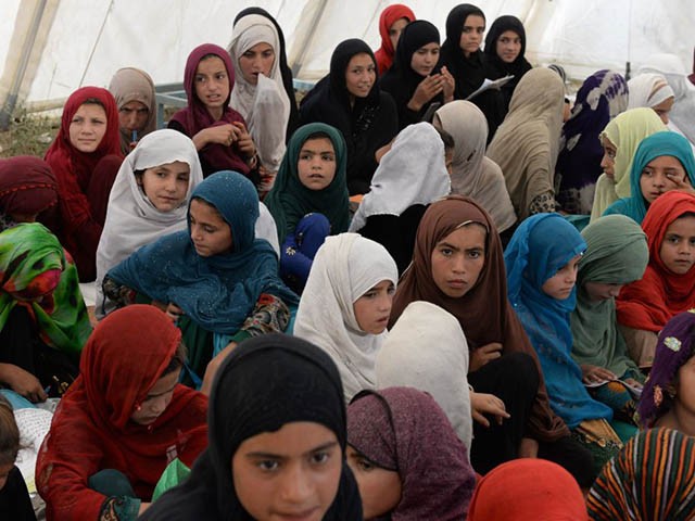 In this photo taken on July 22, 2019, Afghan schoolchildren study at the destroyed Papen High School in Deh Bala district of Nangarhar province. - The US and the Taliban say they are making progress in ongoing peace talks, but little has changed for ordinary Afghans, and recent attacks show how children are as vulnerable as ever in the grinding conflict. (Photo by NOORULLAH SHIRZADA / AFP) / TO GO WITH Afghanistan-conflict-children-education,FOCUS by Thomas Watkins and Noorullah Shirzada (Photo credit should read NOORULLAH SHIRZADA/AFP via Getty Images)