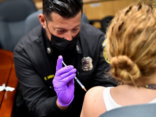 A Culver City Fire Department paramedic administers a dose of the Johnson and Johnson Janssen Covid-19 vaccine at a vaccination clinic on August 5, 2021, in Culver City, California. (Photo by Patrick T. FALLON / AFP) (Photo by PATRICK T. FALLON/AFP via Getty Images)