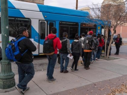 Central American migrants are pictured making their way to El Paso Sun Metro busses after being dropped off in downtown El Paso by Immigration and Customs Enforcement late in the afternoon on Christmas day, December 25, 2018. - About 200 Asylum seekers were dropped off by ICE as part of …