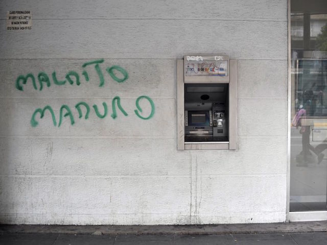 View of a graffiti against Venezuelan President Nicolas Maduro, painted next to an out-of-service ATM in Caracas, Venezuela on January 3, 2018. (Photo by YURI CORTEZ / AFP) (Photo credit should read YURI CORTEZ/AFP via Getty Images)