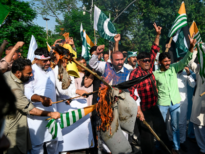 Supporters of ruling Pakistan Tehreek-e-Insaf (PTI) burn an effigy of Indian Prime Ministe