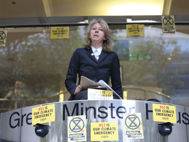 Gail Bradbrook, co-founder of Extinction Rebellion climate action movement, speaks before smashing a window at the front of the building housing the government's Department for Transport in central London on October 15, 2019 as part of Extinction Rebellion's Autumn uprising global protests. (Photo by ISABEL INFANTES / AFP) (Photo by …